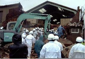 Firefighters examine typhoon-hit house in Kitakyushu